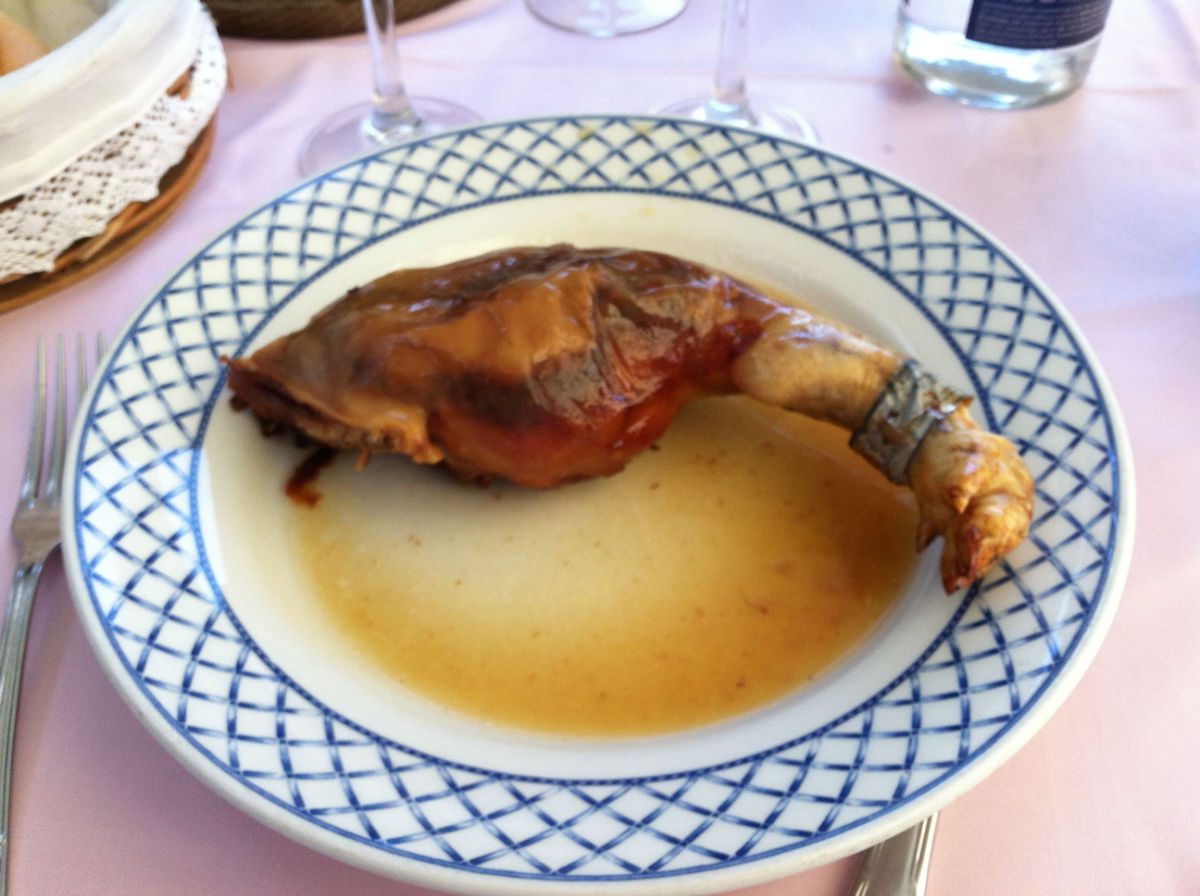 Leg on a plate of a roast suckling pig