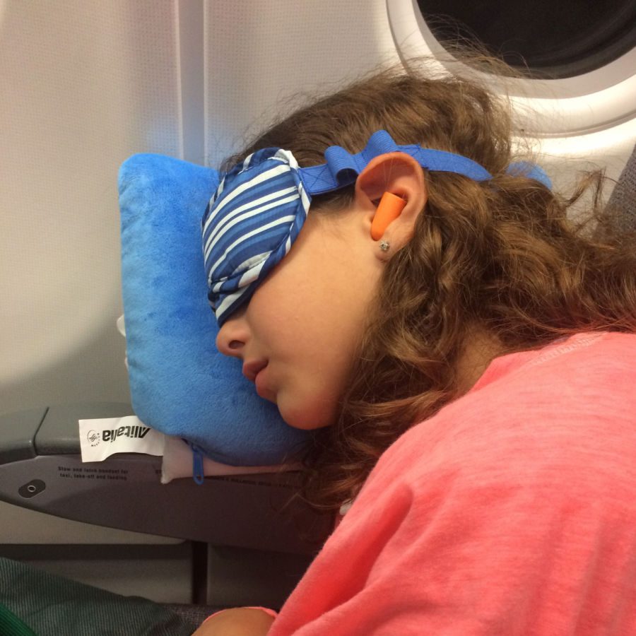 girl with sleep mask asleep on plane