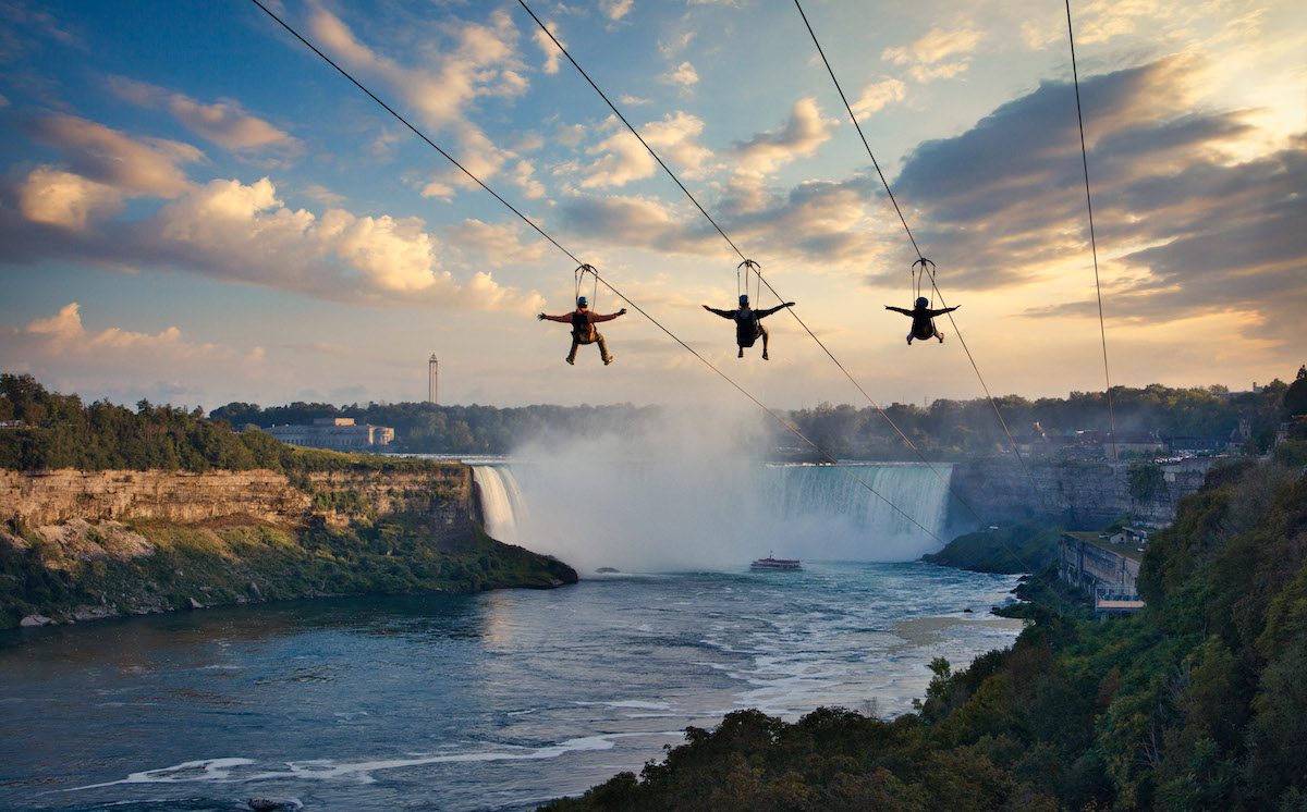 3 people on zipline to the falls