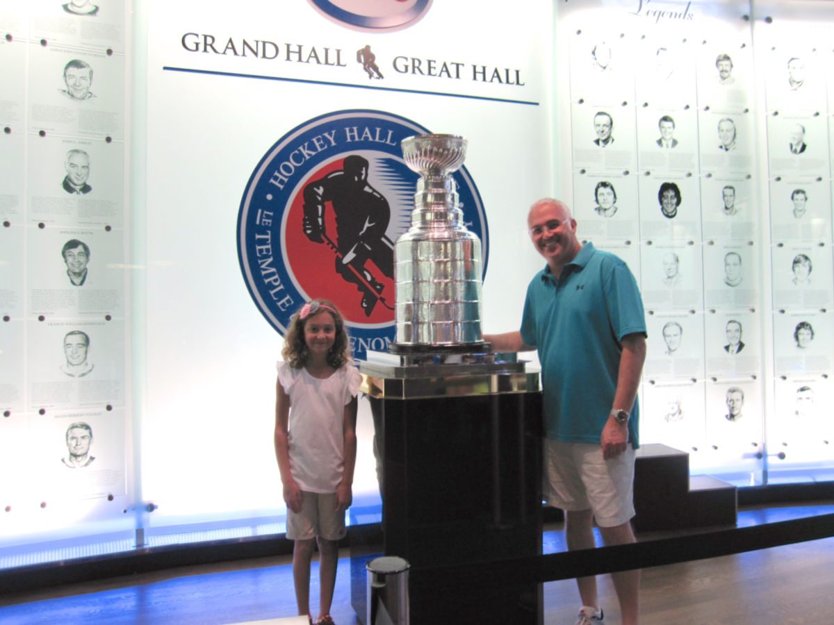 girl and dad with Stanley cup