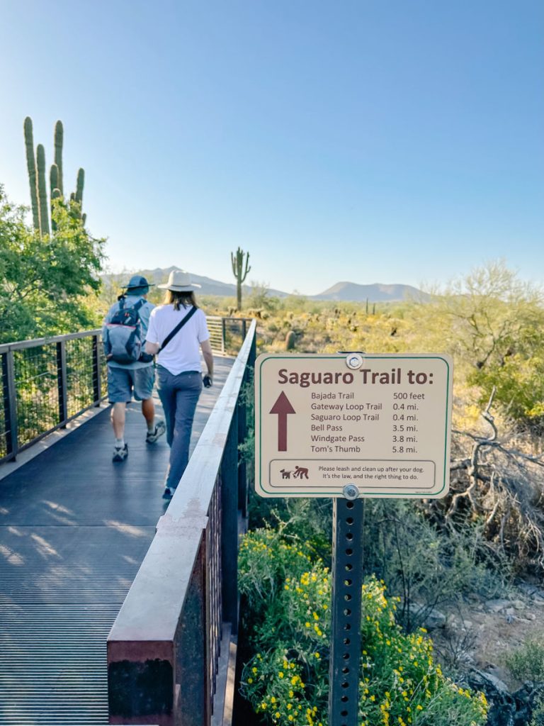 trail sign and bridge to path