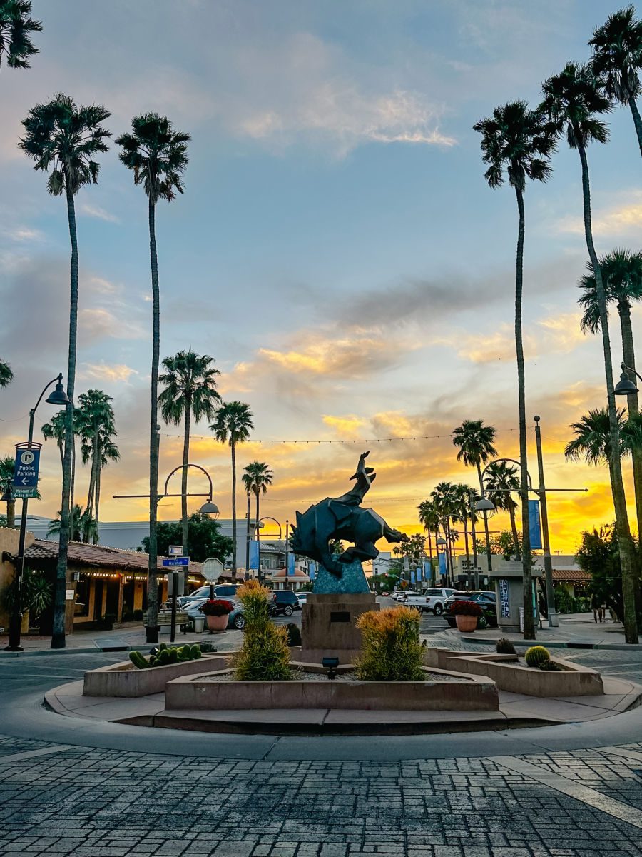 Cowboy statue at sunset