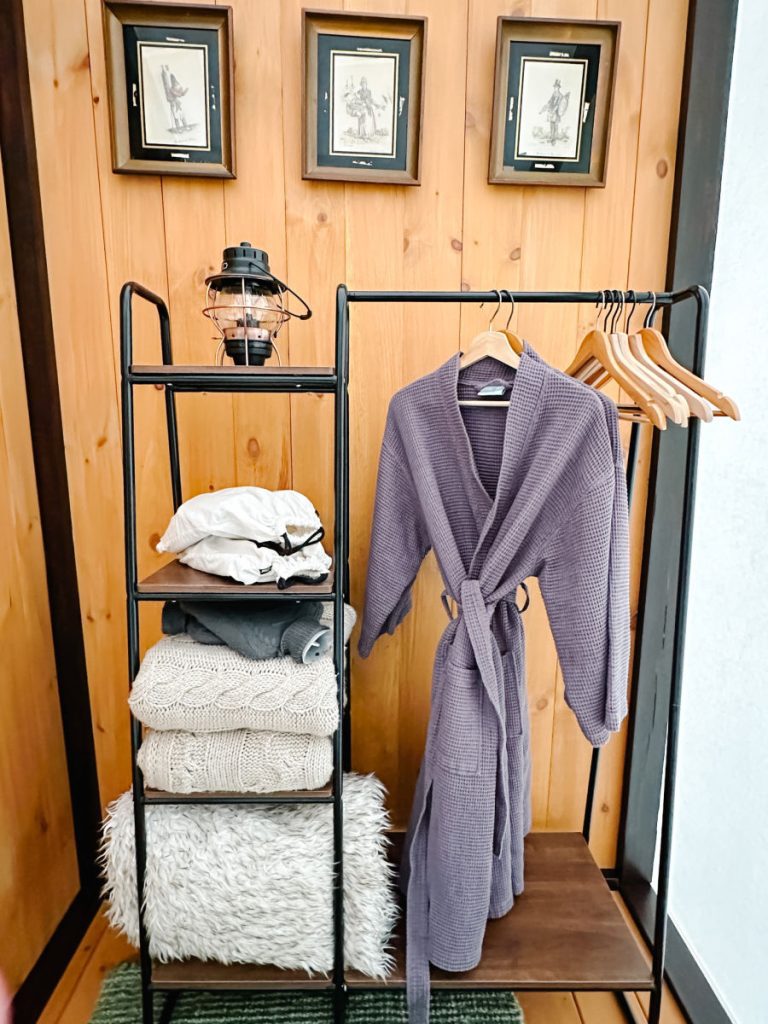 robe and hangers with blankets on a shelf
