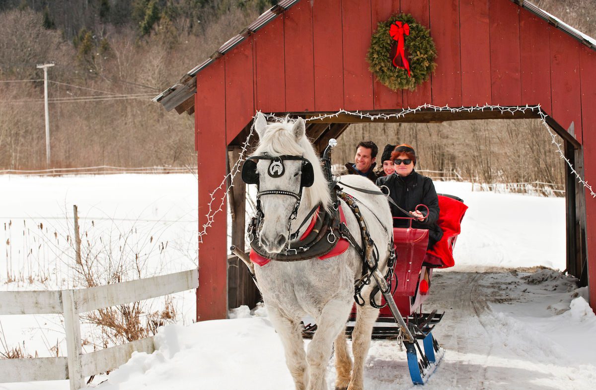 Sleigh ride under red covered bridge