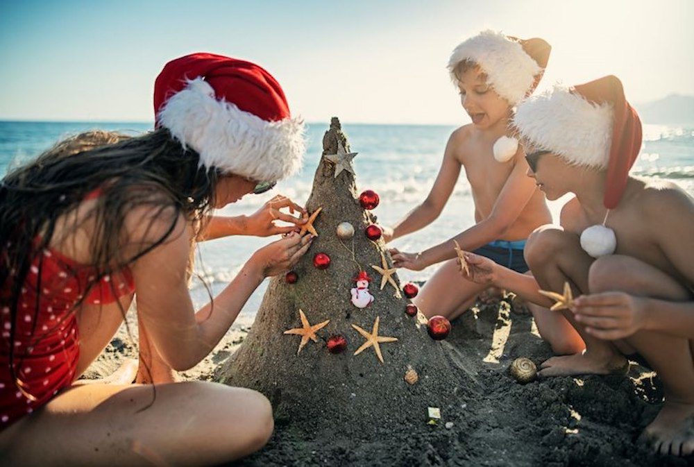 Kids building sand castle christmas tree