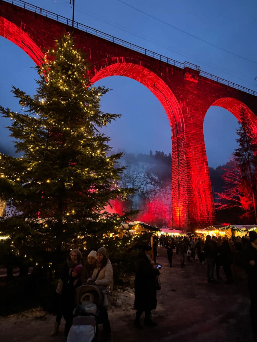 Christmas tree and aqueduct with red uplighting