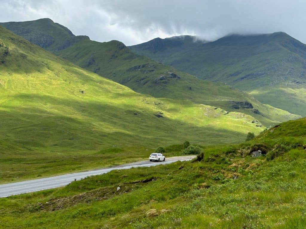 car on road in Scottish Highlands