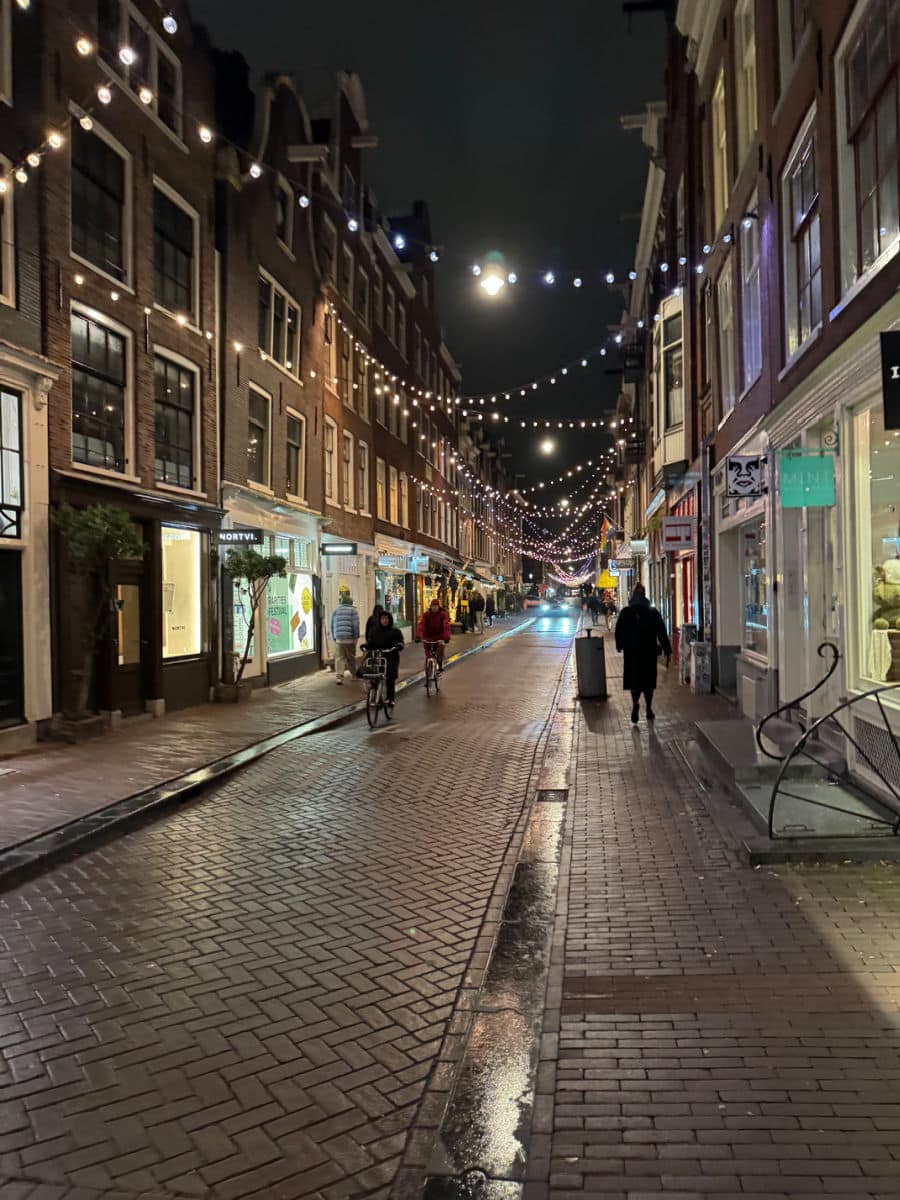 string lights over street in Amsterdam at night