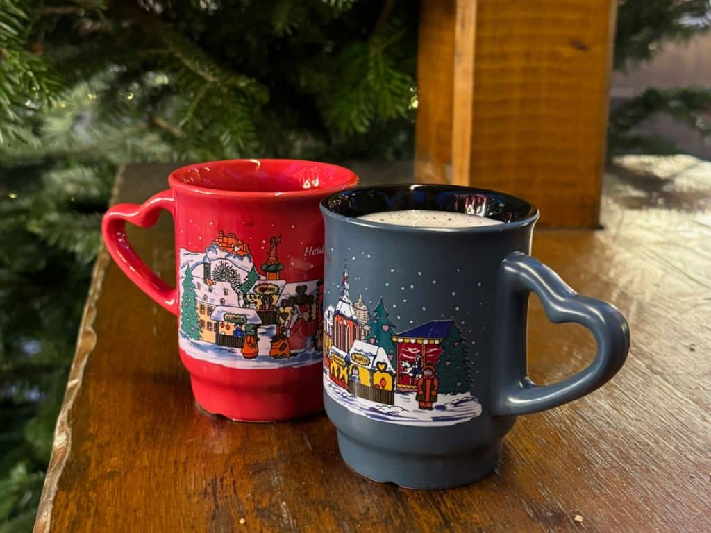 Best German Christmas Market foods with two gluhwein mugs on a table