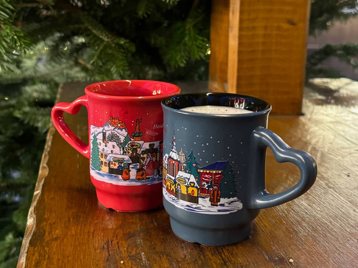 Best German Christmas Market foods with two gluhwein mugs on a table