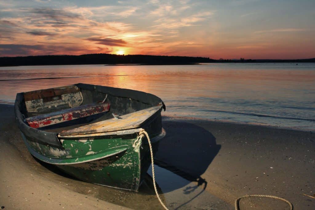 rowboat on Scarborough Beach at sunset Visit Maine