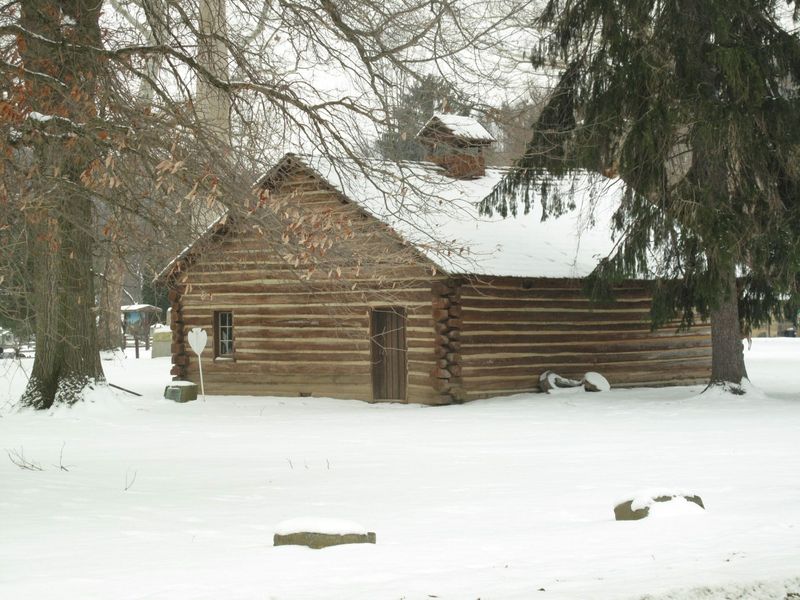 See the Reconstructed Log Cabin and Mission Church
