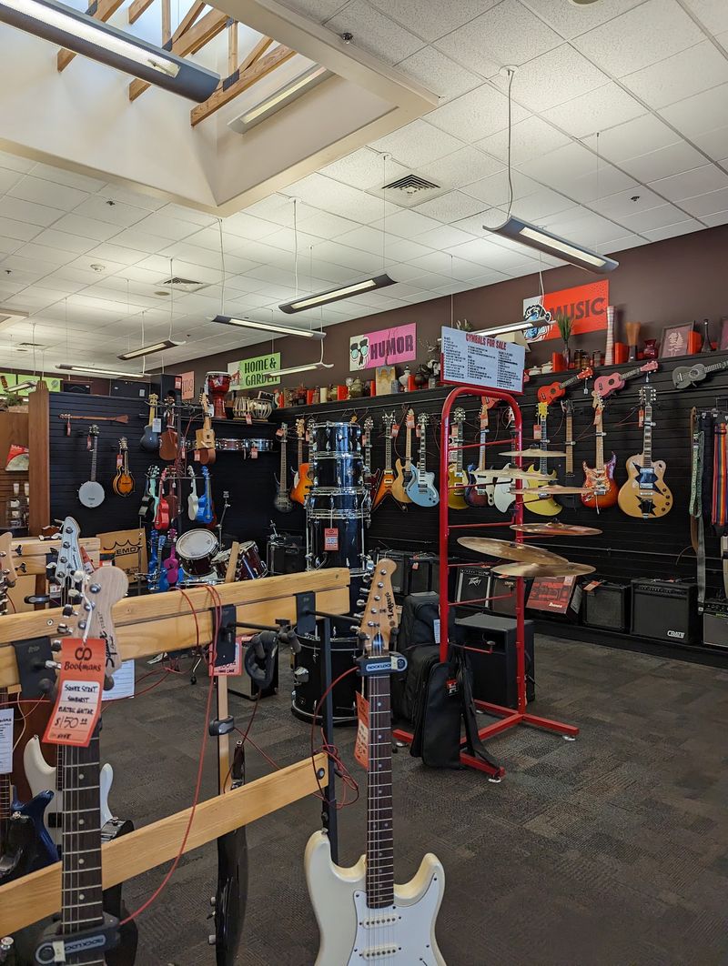 Guitars, Banjos, and a Wall of Music Gear Guitars, Banjos, and a Wall of Music Gear