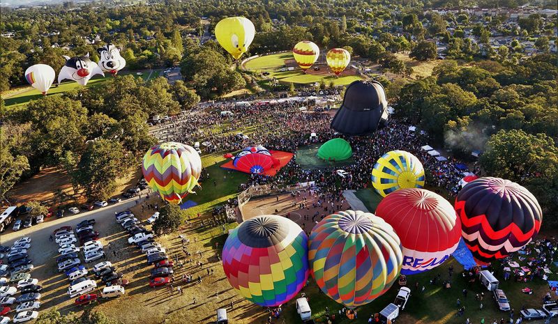 Music, vendors, and attractions expand the outing beyond balloon watching
