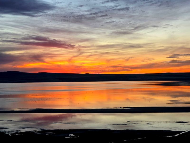 Sunsets And A Glass-Like Surface