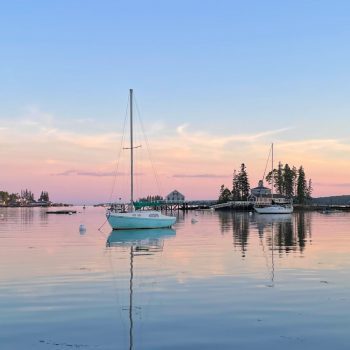 Sailboat on the water in Boothbay Harbor at sunset