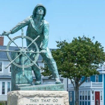 Fishermen's memorial and houses in downtown Gloucester MA