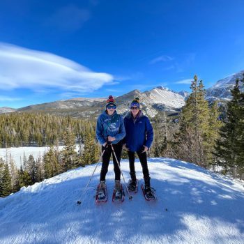 Mother and daughter on mountain in snowshoes in Rocky Mountain National Park