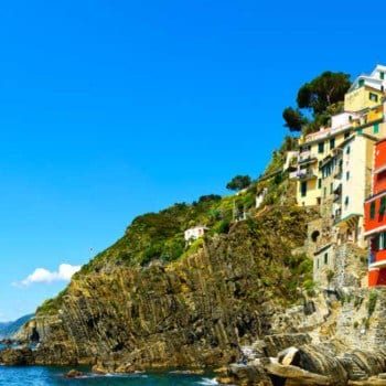 Riomaggiore village panoramic view on cliff rocks, boats and sea., Seascape in Five lands, Cinque Terre National Park, Liguria Italy Europe.